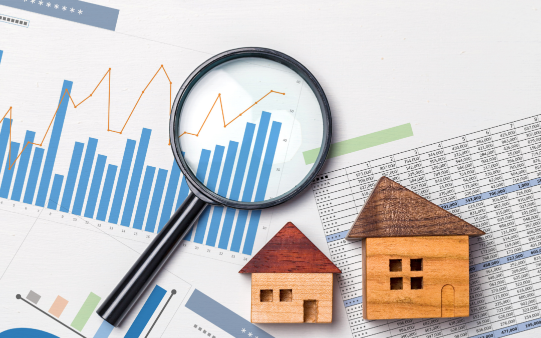 Magnifying class laying on top of printed sheets of graphs, data tables and wooden blocks placed into the shape of two houses