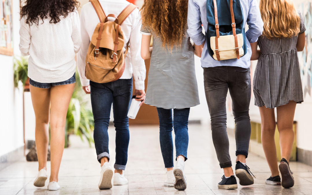 Students walking in a row through the halls of a school