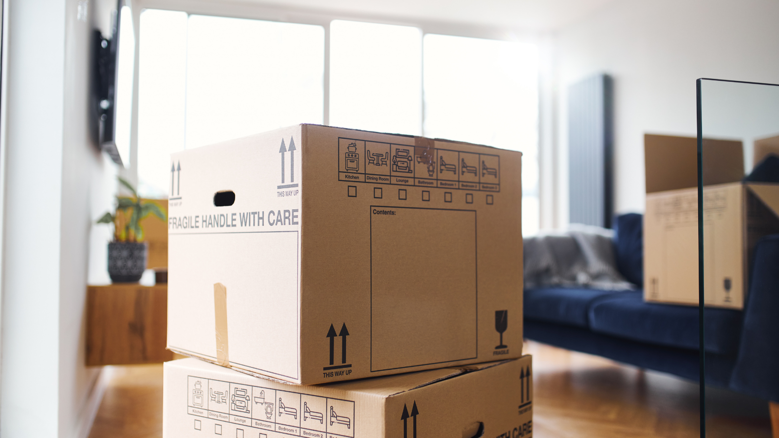 Moving boxes stacked up in a living room